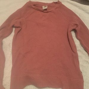Woman’s pink North Face sweater